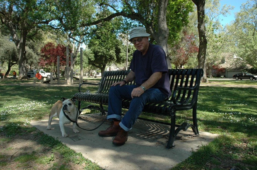 Jack and Rosebud take a break on a park bench in William Land Park. 