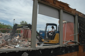 A worker demolishes the Carl's Jr. 