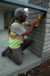 A worker from Adair Construction works on re-invigorating the brick along the renovated building at 1949 Sutterville Road. 